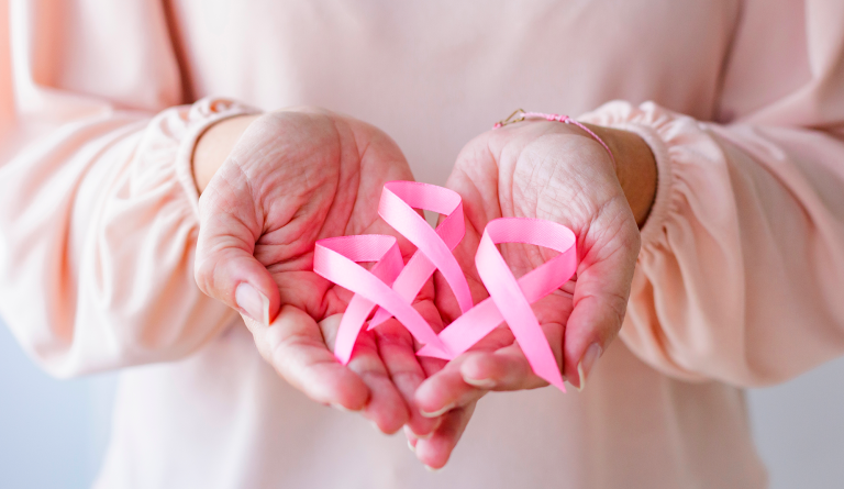 woman with pink ribbons in her hands. Symbol of the Pink Month
