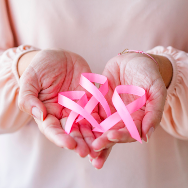 woman with pink ribbons in her hands. Symbol of the Pink Month